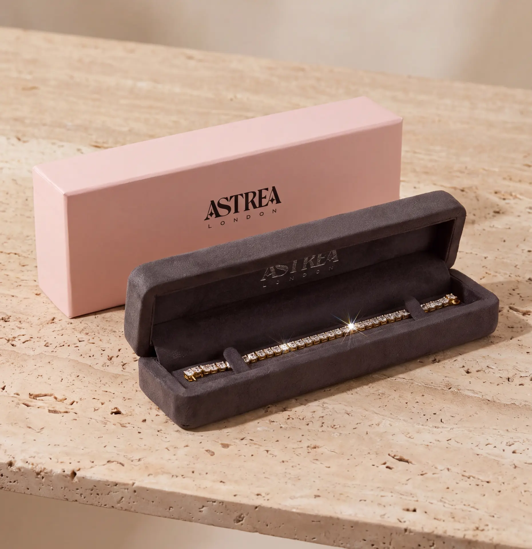 Astrea London bracelet packaging — long suede case and pink outer box