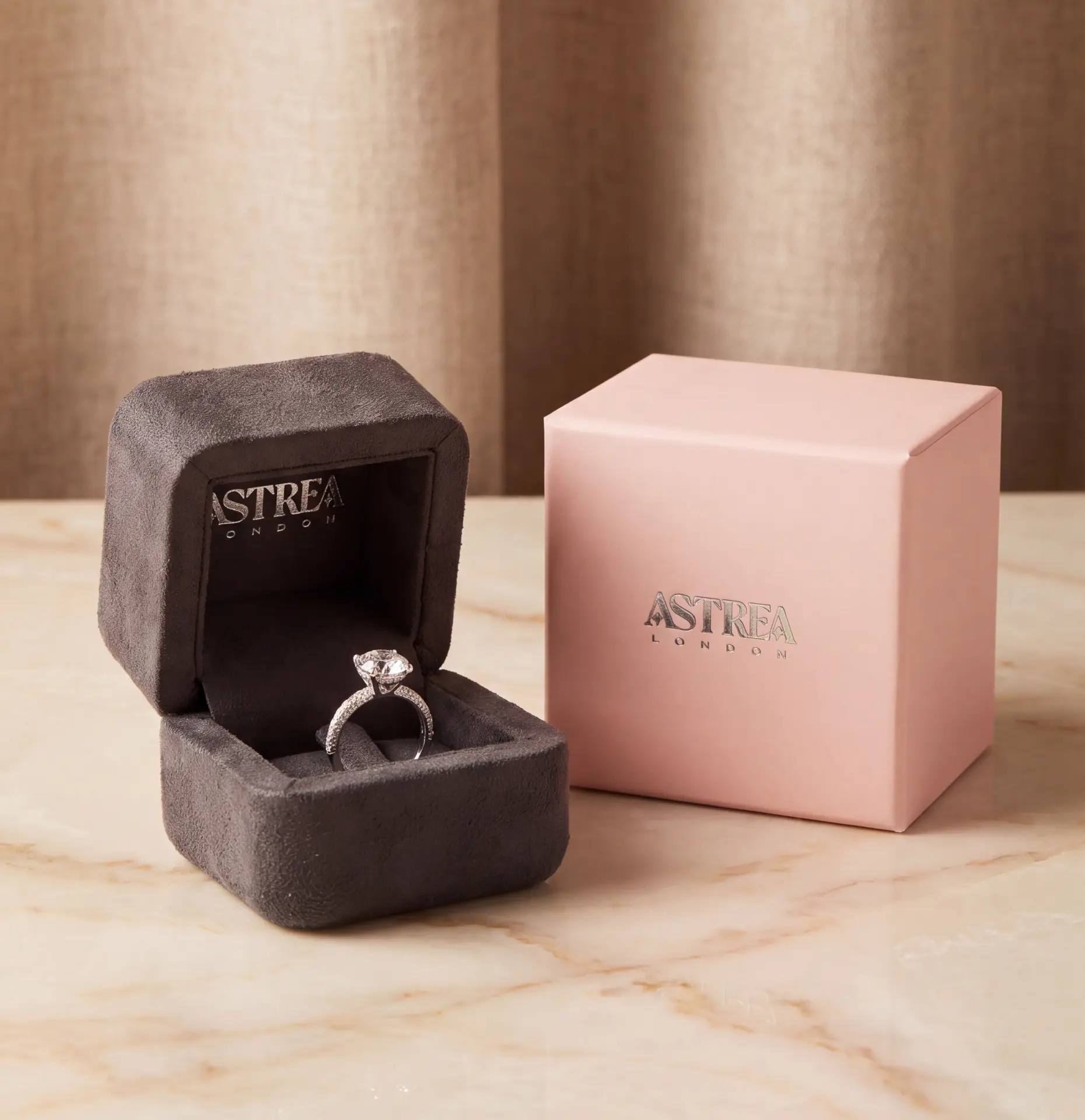 Astrea London ring packaging — grey suede ring box and pink outer box